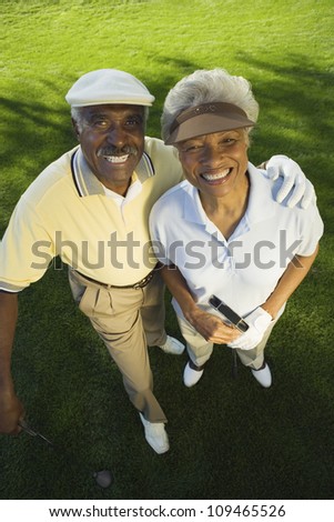 High angle view of an African American couple with arm around on golf course