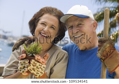 Portrait of a happy senior couple gardening together