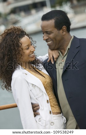 Happy loving African American couple on the yacht