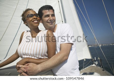 Man embracing woman from behind on the yacht during vacation