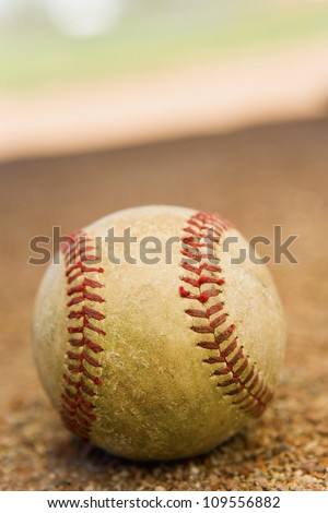 Baseball laying in the base path on a baseball field