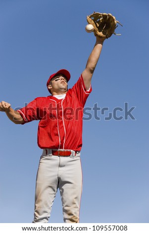 Baseball player trying to catch ball