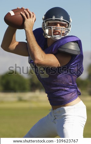 American football player about to throw the ball
