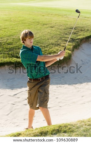 Young golf player after hitting the ball