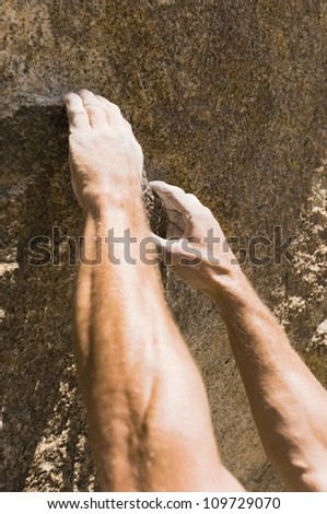Closeup of man's hand rock climbing