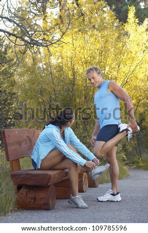 Man and woman preparing themselves for a jog