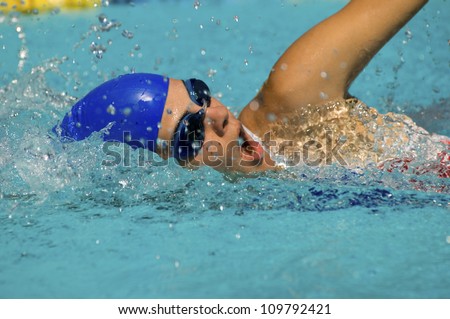 Swimmer doing a freestyle swimming in a swimming pool
