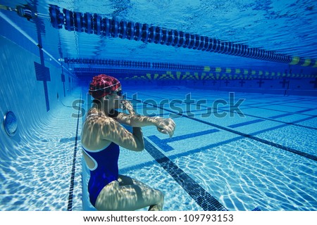 Female swimmer holding her breath underwater