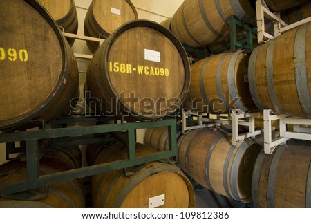 Wine barrels stored in an old cellar of the winery