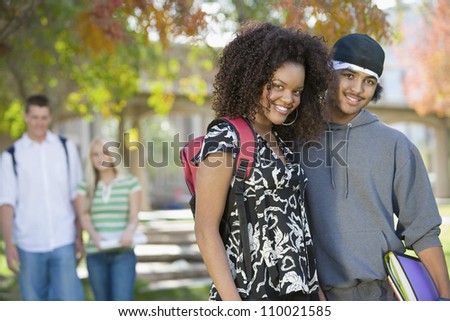 Portrait of an African American friends with classmates in the background