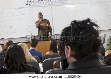 An African American male professor teaching students
