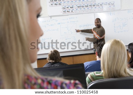 An African American male teacher teaching students