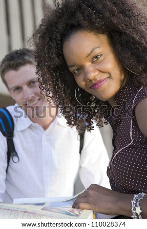 African American female student with friend studying