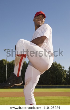 Baseball pitcher winding up to throw the baseball