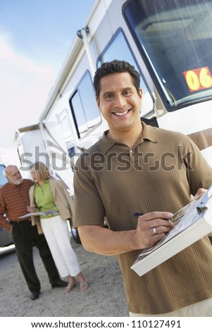Man holding guide book with passengers in the background