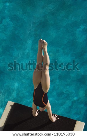 High angle view of a female diver diving into the pool
