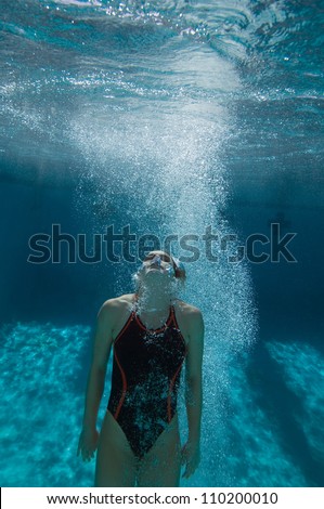 Female diver holding breath underwater