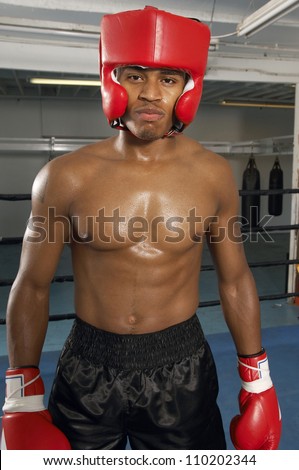 Portrait of a professional boxer wearing gloves and protective headgear