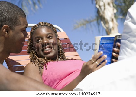 Young African American man with woman holding book