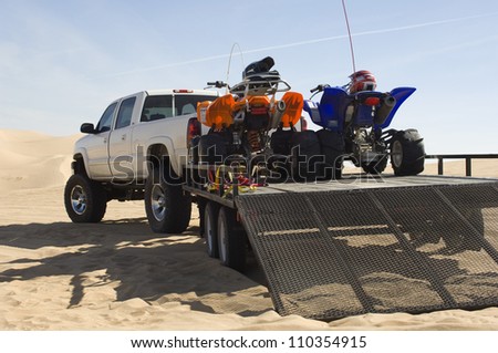 Quad bikes on trailer in desert
