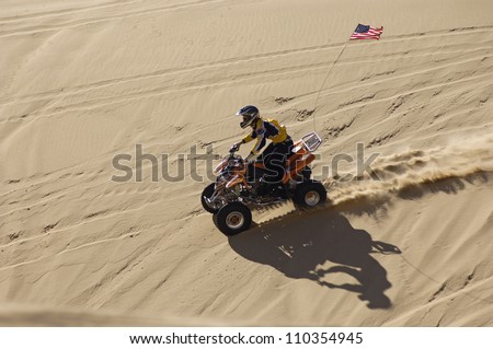 Man riding quad bike in desert from above