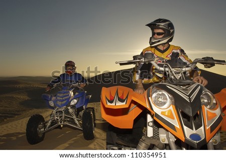 Two quad bike racers sitting on their bike