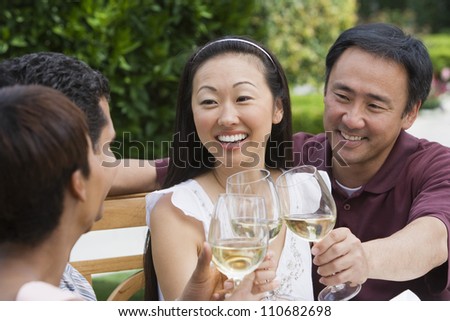 Happy friends tasting wine