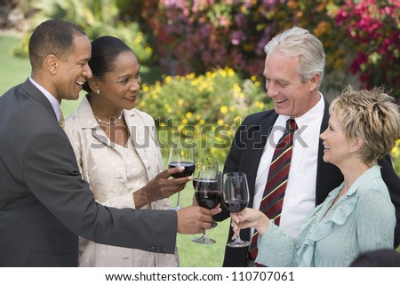 Happy group of friends toasting wine together