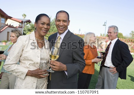 Middle aged couple toasting wine together