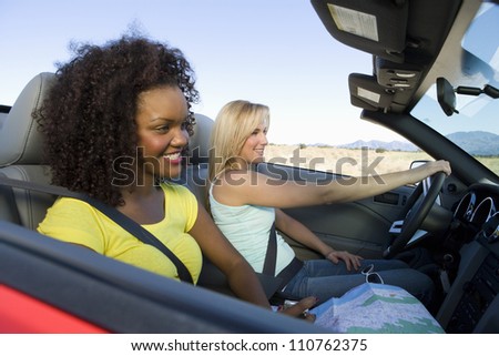 Happy young female friends on a drive