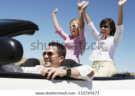 Group of happy friends enjoying their journey in car