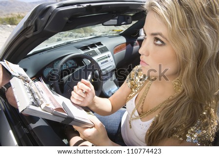 Beautiful young woman writing on traffic ticket