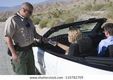 Traffic cop checking woman\'s license