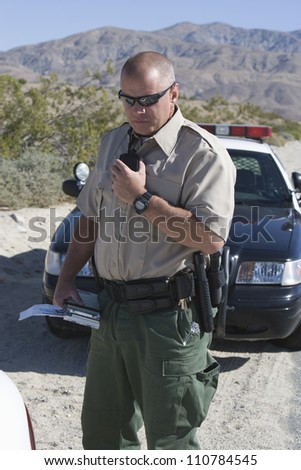 Traffic officer holding walkie-talkie