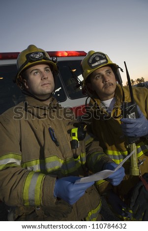 Male firefighters in safety uniform looking away