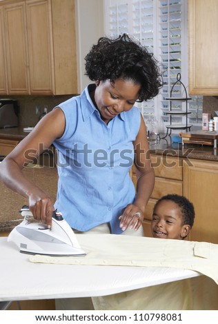 African American woman ironing clothes