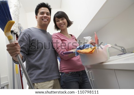 Portrait of happy couple ready to clean the house
