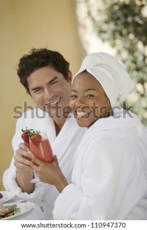 Happy couple drinking srtawberry shake