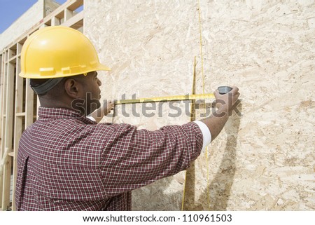 African american man measuring at construction site