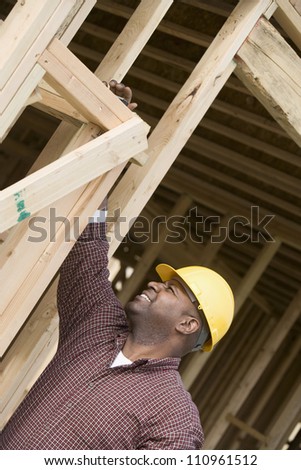 Worker examining form work at construction site