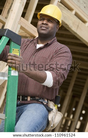 African american worker examining form work at construction site