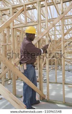 Worker measuring wooden form work