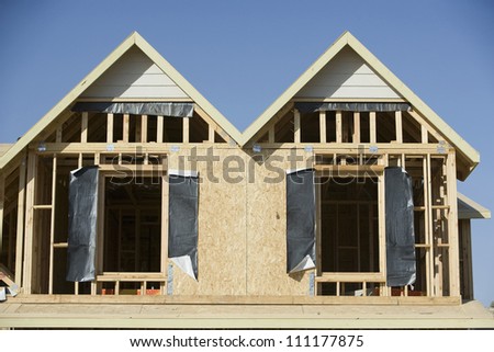 Windows of new wooden house under construction