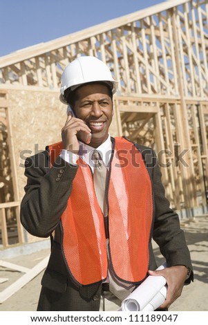 Architect wearing vest as he\'s on call at construction site