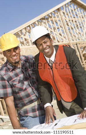 Happy architect and builder at construction site