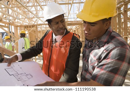 Architect and builder at construction site
