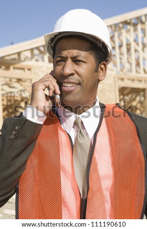 Architect wearing vest as he\'s on call at construction site