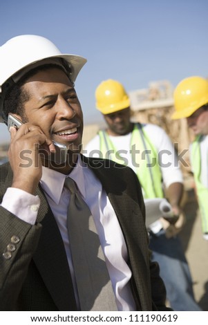 Architect making a call at a construction site