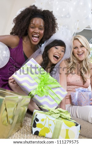 Portrait of multiethnic friends with gifts screaming at party