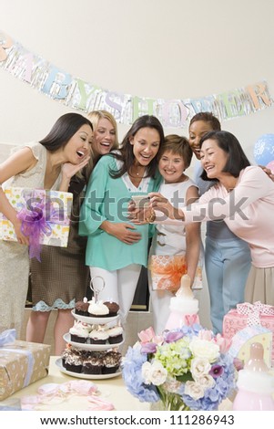 Group of female friends making self-portrait in baby shower party